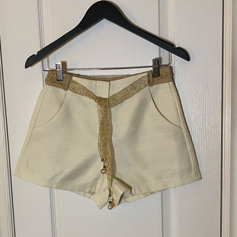 Cream high waisted shorts with gold metallic belt